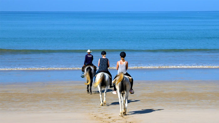 riding horses on the beach